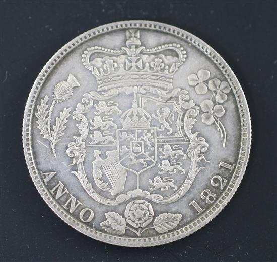 A George IV silver half crown 1821, knock to edge at 11 oclock otherwise EF, toned